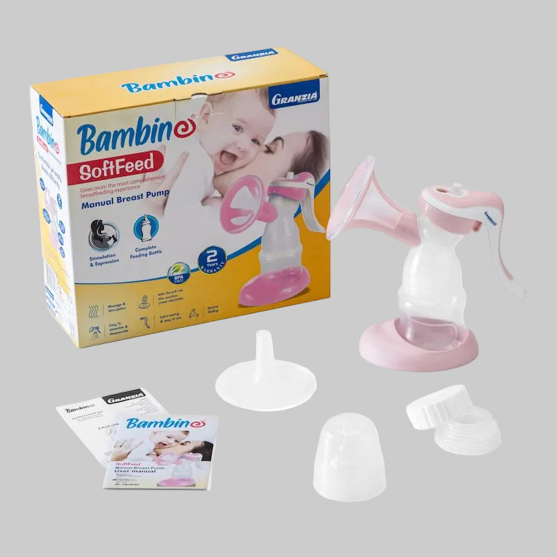 Packaging and components of a Bambini Softfeed breast pump, including the pump unit in pink and white, a breast shield, and a storage bag.